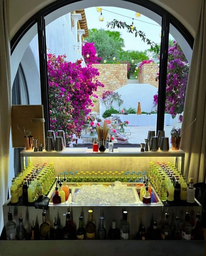 Terrasse fleurie aménagée pour une réception avec un bar